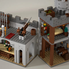 Detailed model of a castle with various structures and accessories on a neutral background