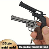 Two miniature revolvers held in a hand with a white background
