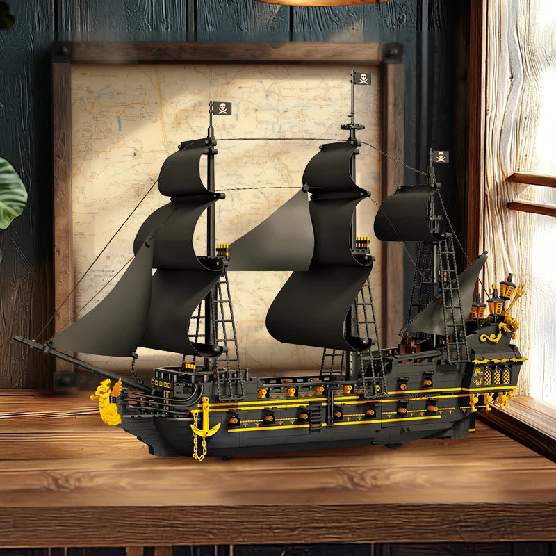 Model of a pirate ship on a wooden surface with a map in the background