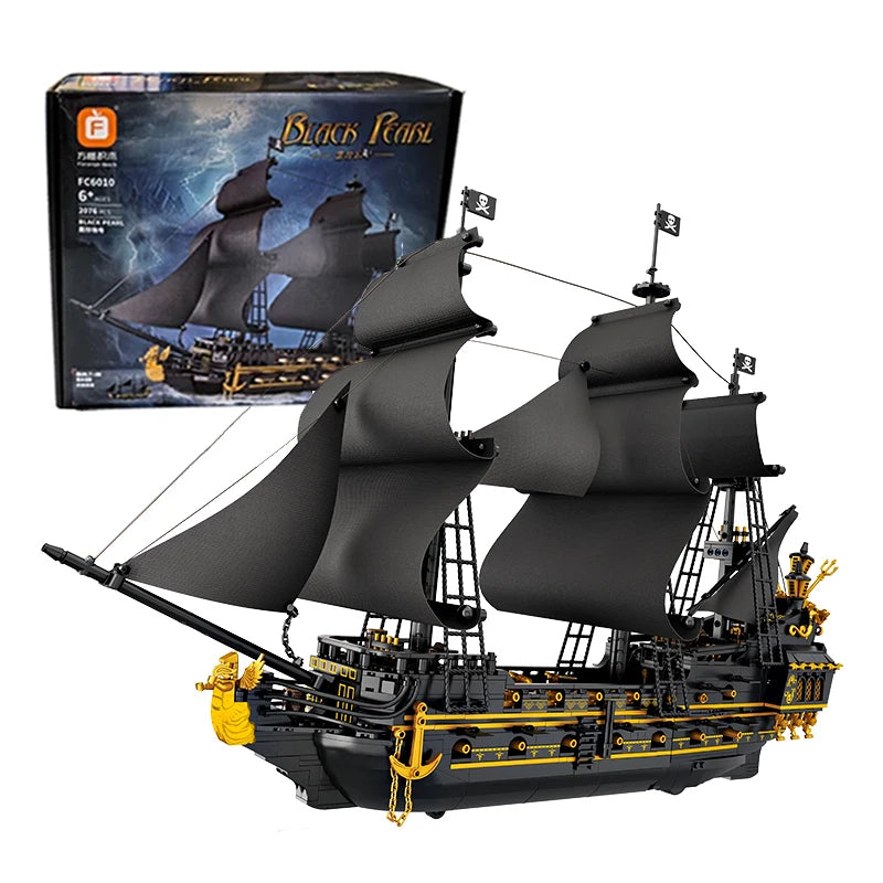Pirate ship model with black sails and gold accents, alongside its packaging.