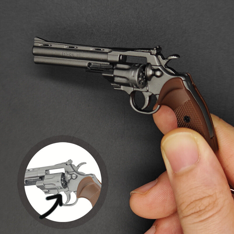Revolver held by a hand with close-up inset on a dark background