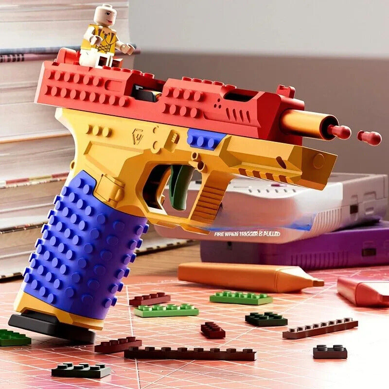 Toy gun with colorful design on a table with scattered building blocks