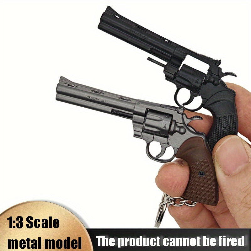 Two miniature revolvers held in a hand with a white background
